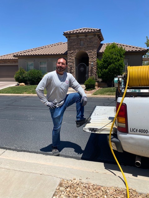 Kevin Brown, owner of All American Pest Control, standing beside his service truck