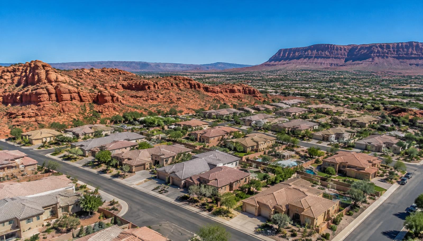 Aerial view of St. George homes below red rock formations